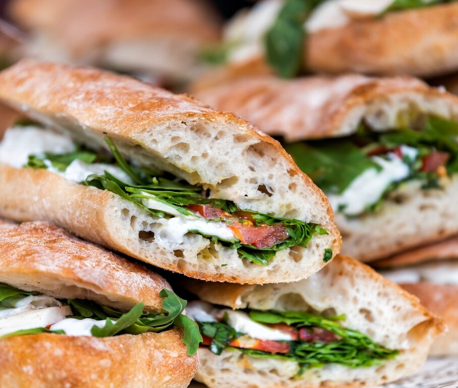 close up of fresh panini sandwiches piled in a cafe